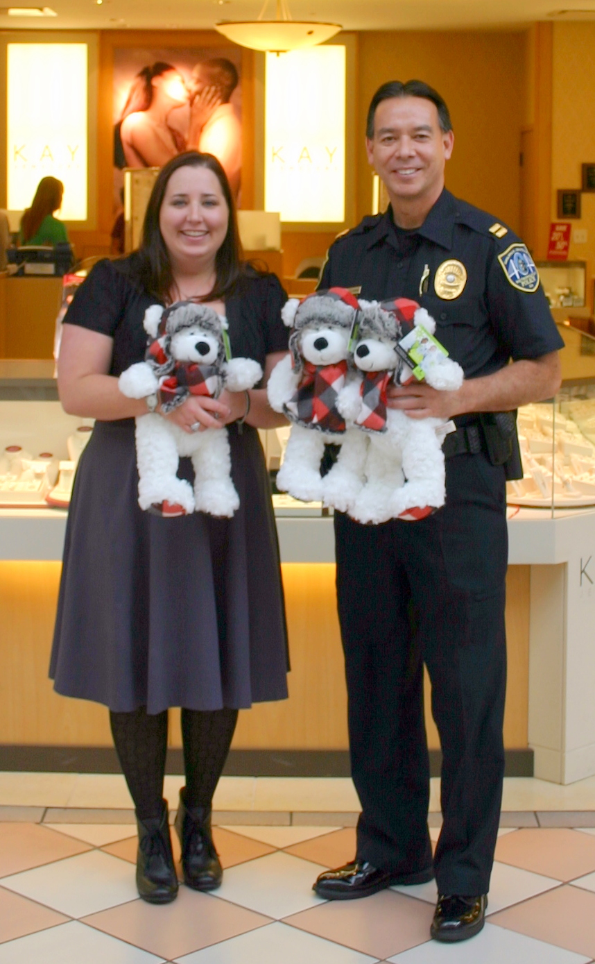 Kay manager Karen Campbell donates bears to SCMPD Southside Precinct Commander Capt. Dean Fagerstrom