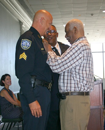 Sgt  Bill Sharpley is Pinned by 50-year Detective Clifford Perry.