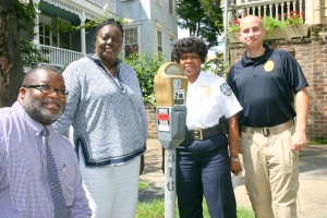 Mobility and Parking Services Assistant Director Leonard Bostick Director Veleeta McDonald Police Chief Julie Tolbert Sgt  Eddie Grant display new signs.